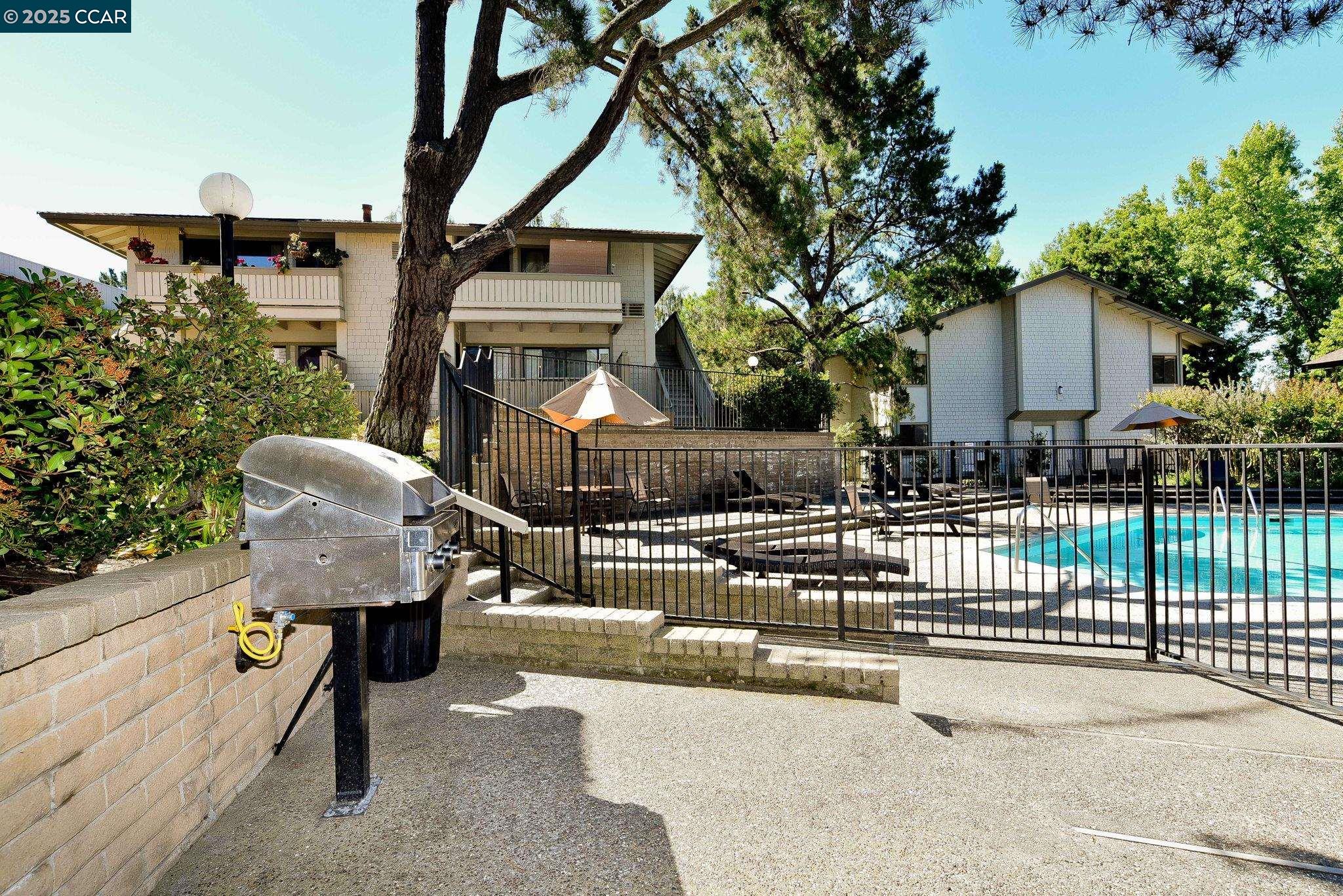 1411 Marchbanks Drive, Unit 2 Walnut Creek, CA 94598 - Photo 33 of 42 a view of a house with wooden deck and furniture