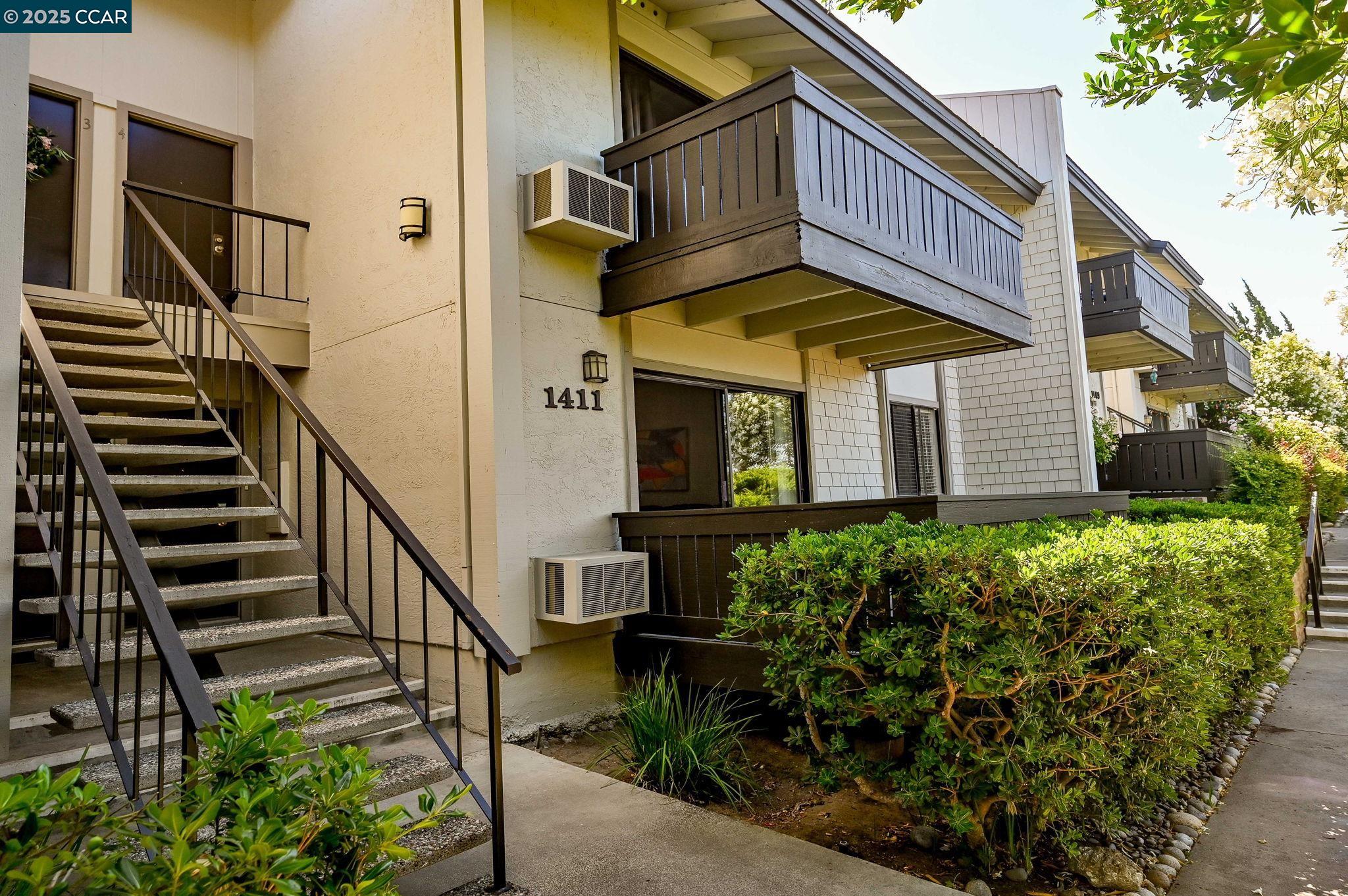 1411 Marchbanks Drive, Unit 2 Walnut Creek, CA 94598 - Photo 40 of 42 a view of a house with wooden fence and potted plants