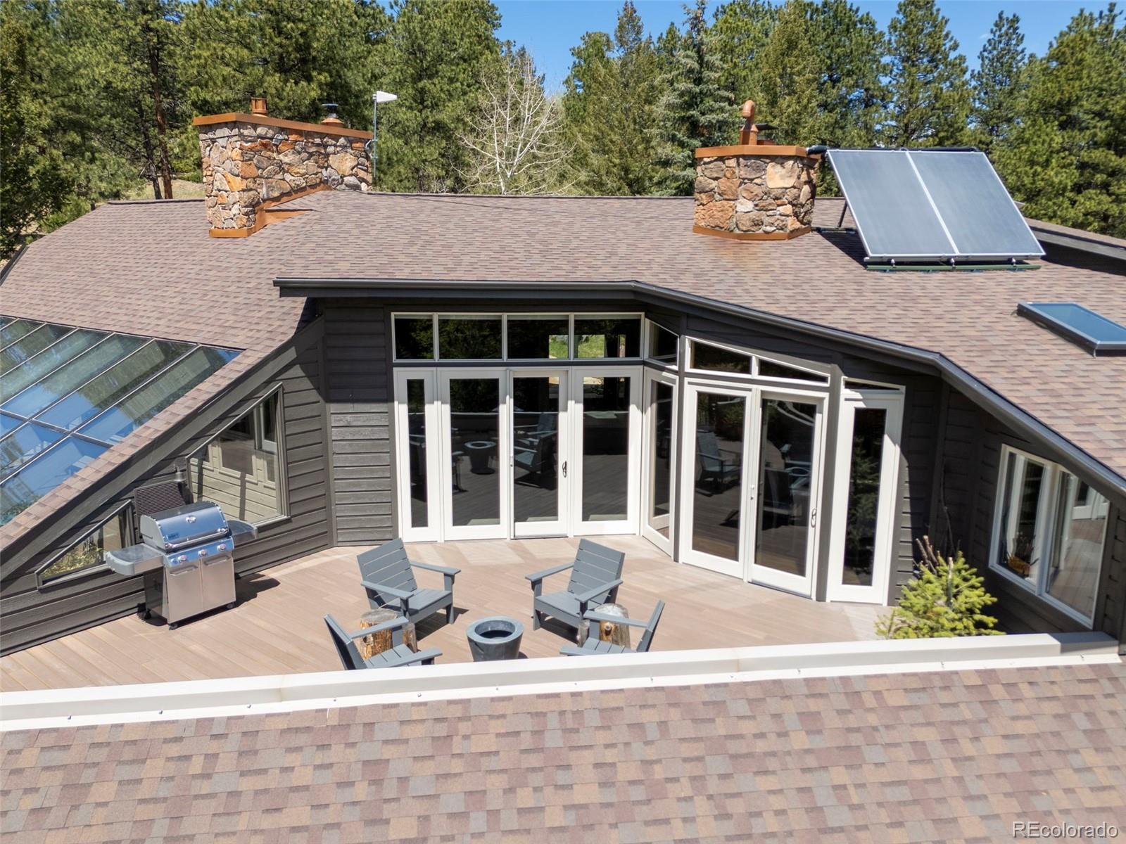 1323 South Snyder Gulch Road Evergreen, CO 80439 - Photo 16 of 47 a backyard of a house with seating space