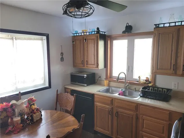a kitchen with a sink stove and cabinets