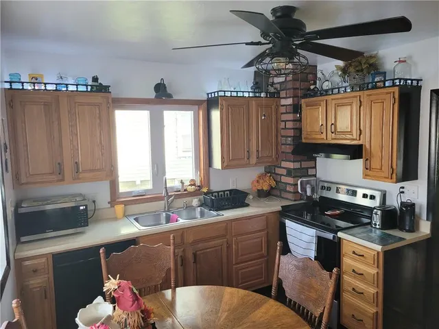 a kitchen with a sink stove and cabinets