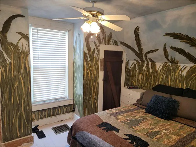 a bedroom with a bed and a chandelier