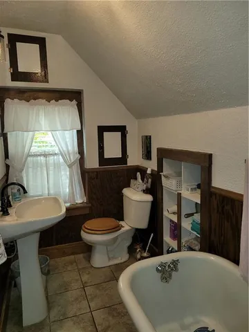 a bathroom with a sink toilet mirror and vanity