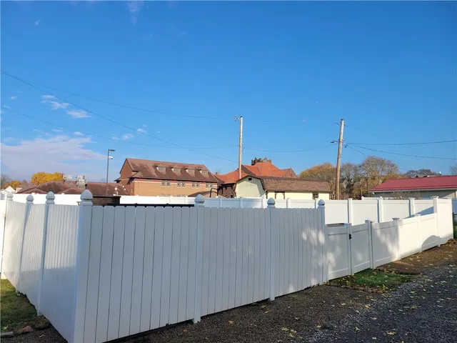 a view of a patio with chairs and umbrellas