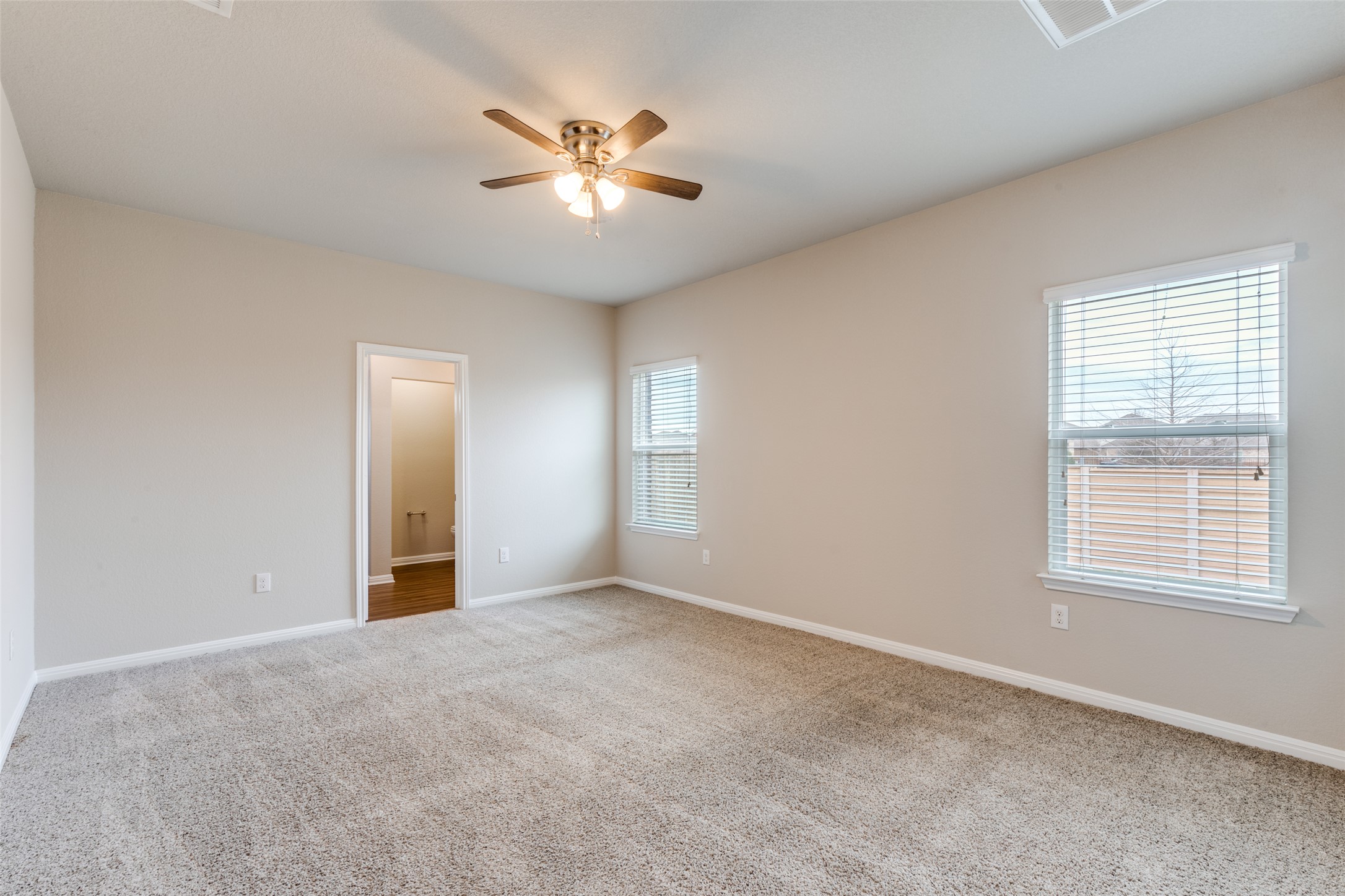 348 Shiner Lane Georgetown, TX 78626 - Photo 16 of 37 an empty room with chandelier fan and windows