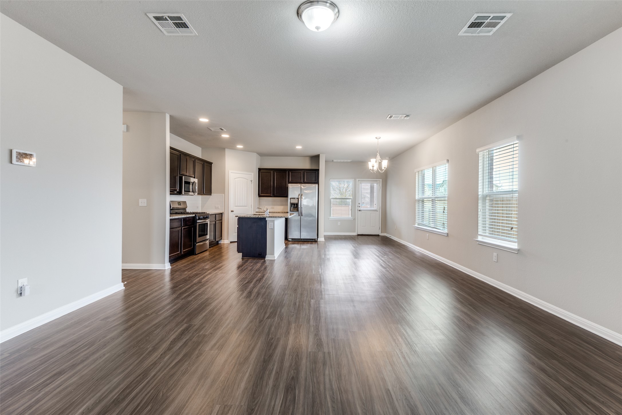 348 Shiner Lane Georgetown, TX 78626 - Photo 3 of 37 a view of kitchen with cabinets and wooden floor