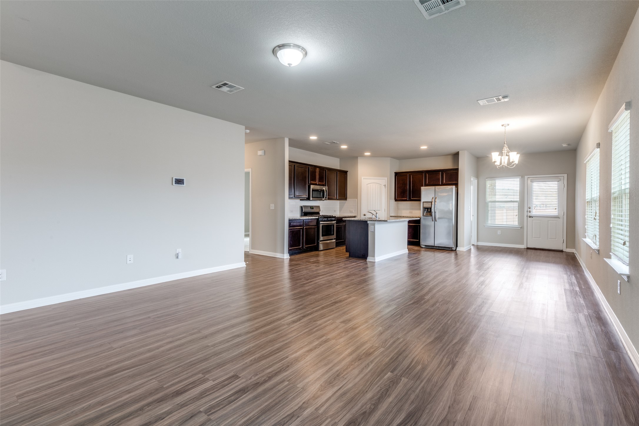 348 Shiner Lane Georgetown, TX 78626 - Photo 5 of 37 a view of large kitchen with wooden floor and a window