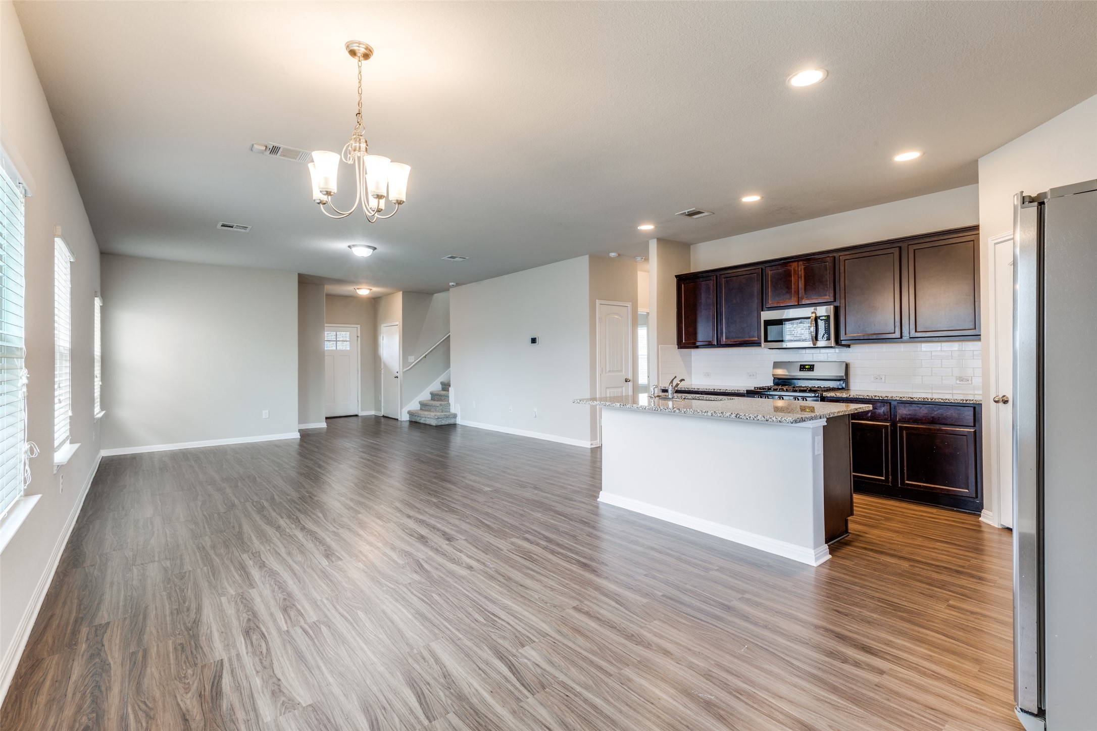 348 Shiner Lane Georgetown, TX 78626 - Photo 9 of 37 a view of a kitchen with a sink stainless steel appliances and cabinets