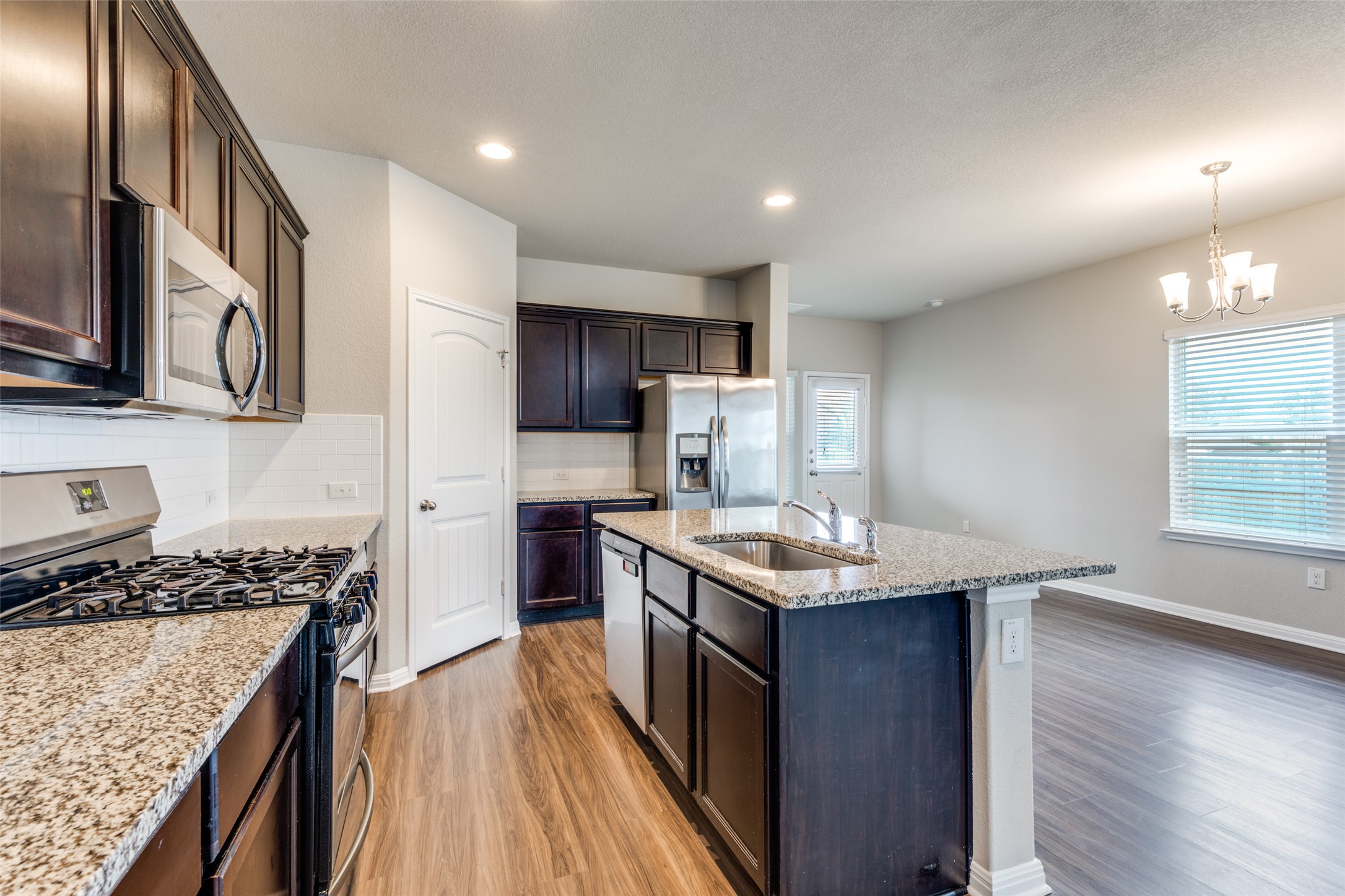 348 Shiner Lane Georgetown, TX 78626 - Photo 10 of 37 a kitchen with stainless steel appliances granite countertop a sink stove and refrigerator
