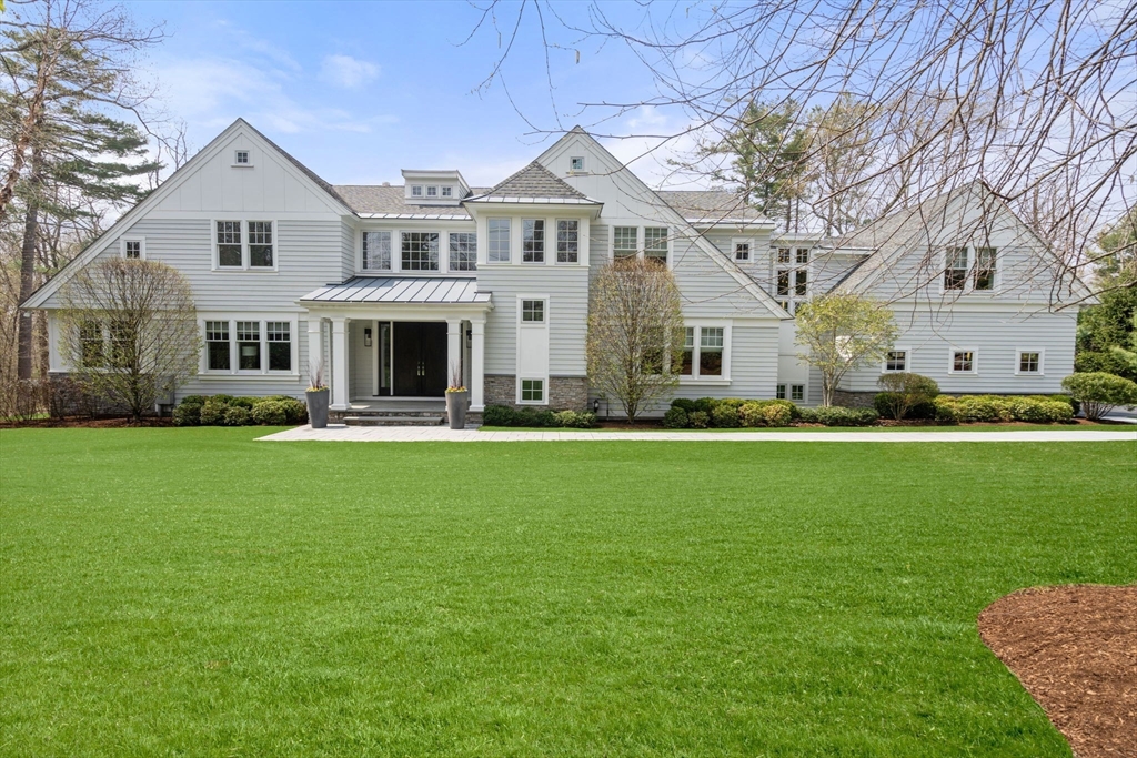 72 Love Lane Weston, MA 02493 - Photo 1 of 41 a front view of a house with a garden and trees