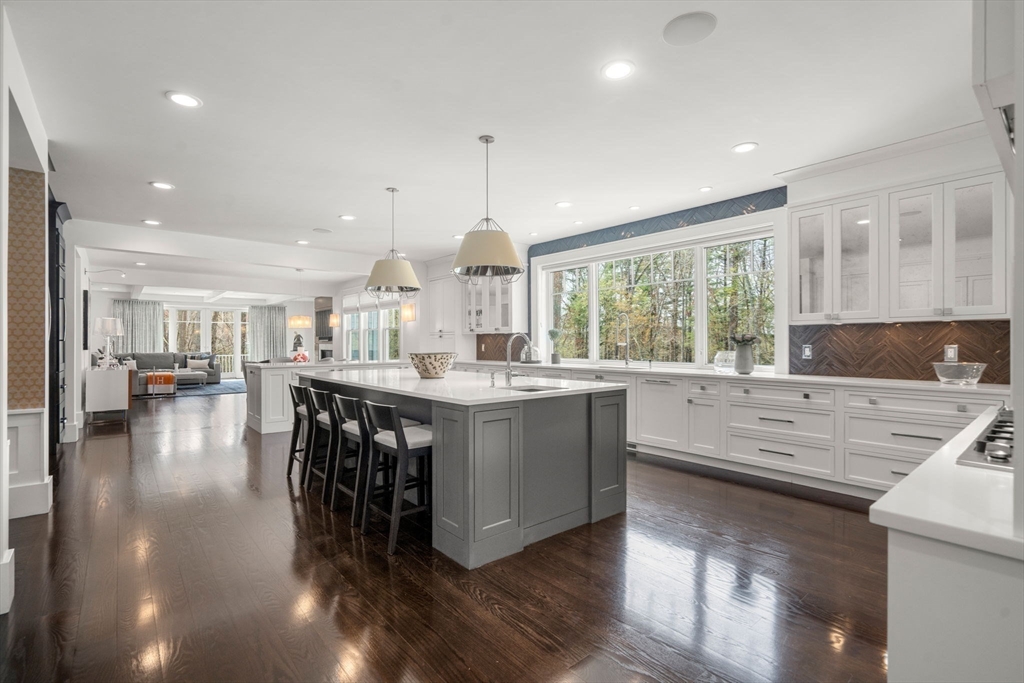72 Love Lane Weston, MA 02493 - Photo 13 of 41 a kitchen with stainless steel appliances granite countertop a stove a sink a oven and a dining table with wooden floor