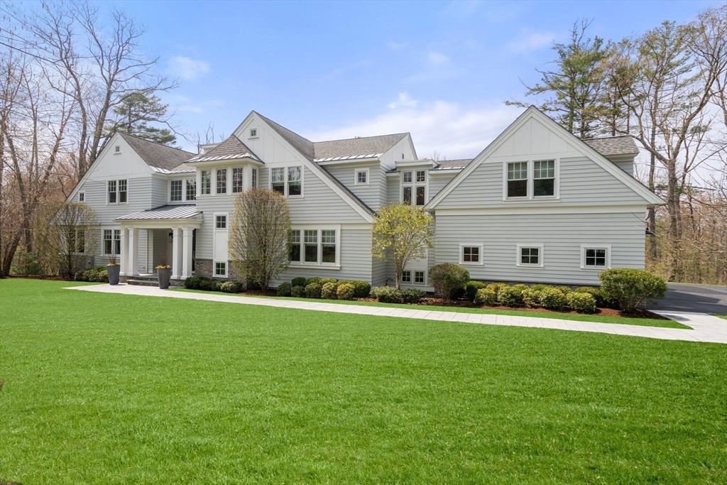72 Love Lane Weston, MA 02493 - Photo 2 of 41 a front view of a house with a yard and garage