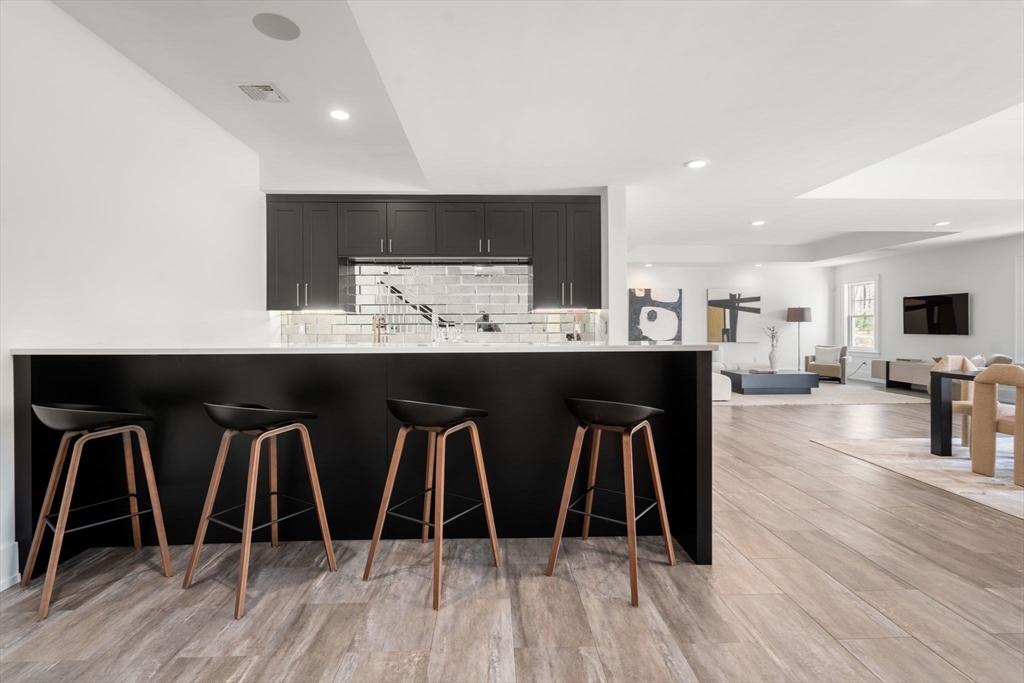 72 Love Lane Weston, MA 02493 - Photo 32 of 41 a dining hall with stainless steel appliances granite countertop a table chairs refrigerator and sink