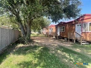 a view of backyard of house with green space