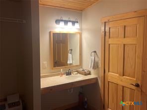 1104 Rorem Avenue Palacios, TX 77465 - Photo 14 of 17 a bathroom with a double vanity sink and a mirror