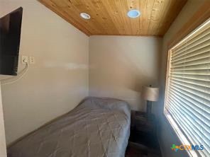 1104 Rorem Avenue Palacios, TX 77465 - Photo 17 of 17 a view of a room with wooden floor and a flat screen tv