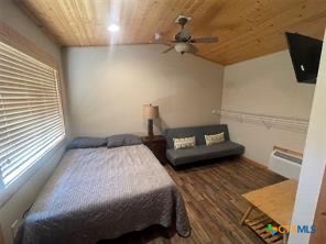 1104 Rorem Avenue Palacios, TX 77465 - Photo 8 of 17 a bedroom with a bed and a flat screen tv