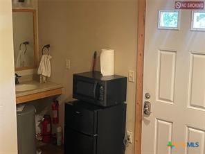 1104 Rorem Avenue Palacios, TX 77465 - Photo 9 of 17 a bathroom with a granite countertop sink and vanity