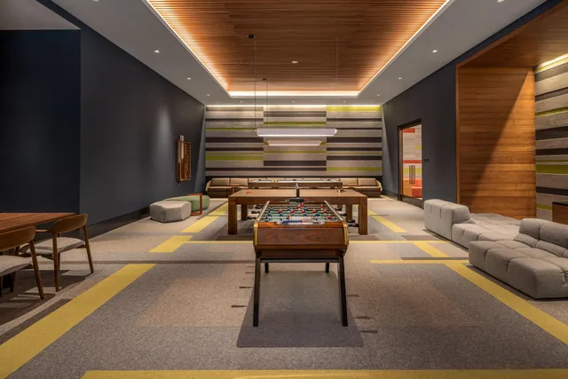 a reading room with furniture and a rug