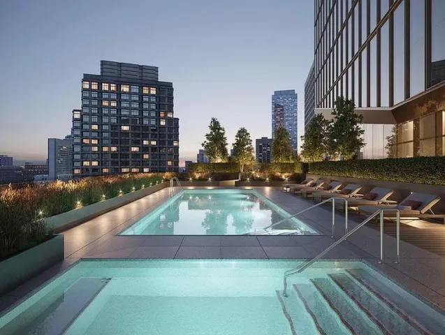 a view of a swimming pool with outdoor seating and plants
