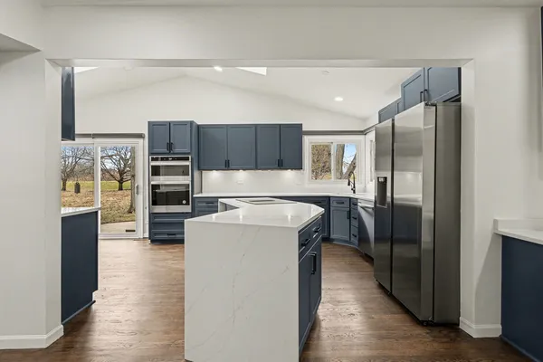 a kitchen with stainless steel appliances a refrigerator and a stove