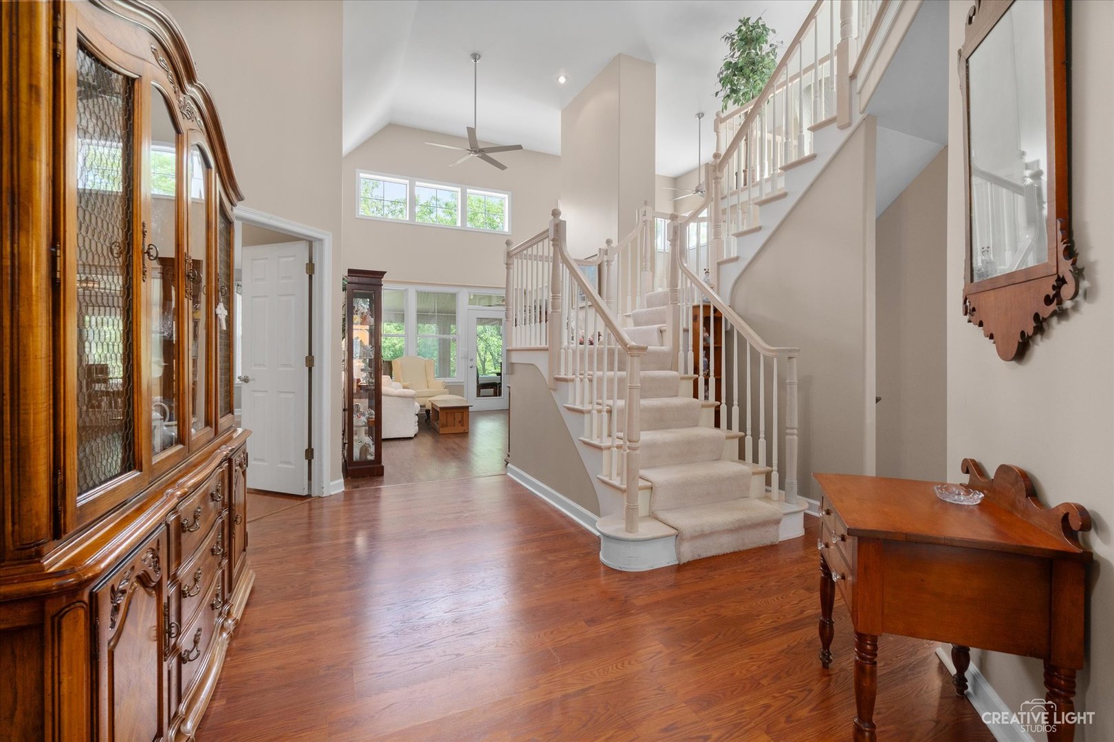 708 Viewpointe Drive St. Charles, IL 60174 - Photo 3 of 38 a view of a hallway with couches and a dining table with wooden floor