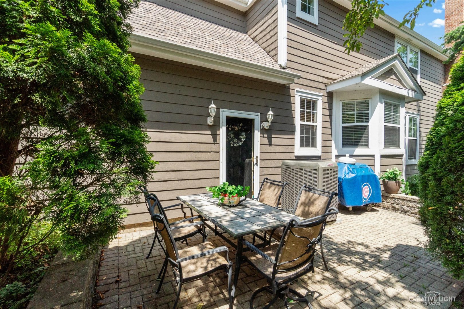 708 Viewpointe Drive St. Charles, IL 60174 - Photo 36 of 38 a view of a patio with table and chairs and potted plants