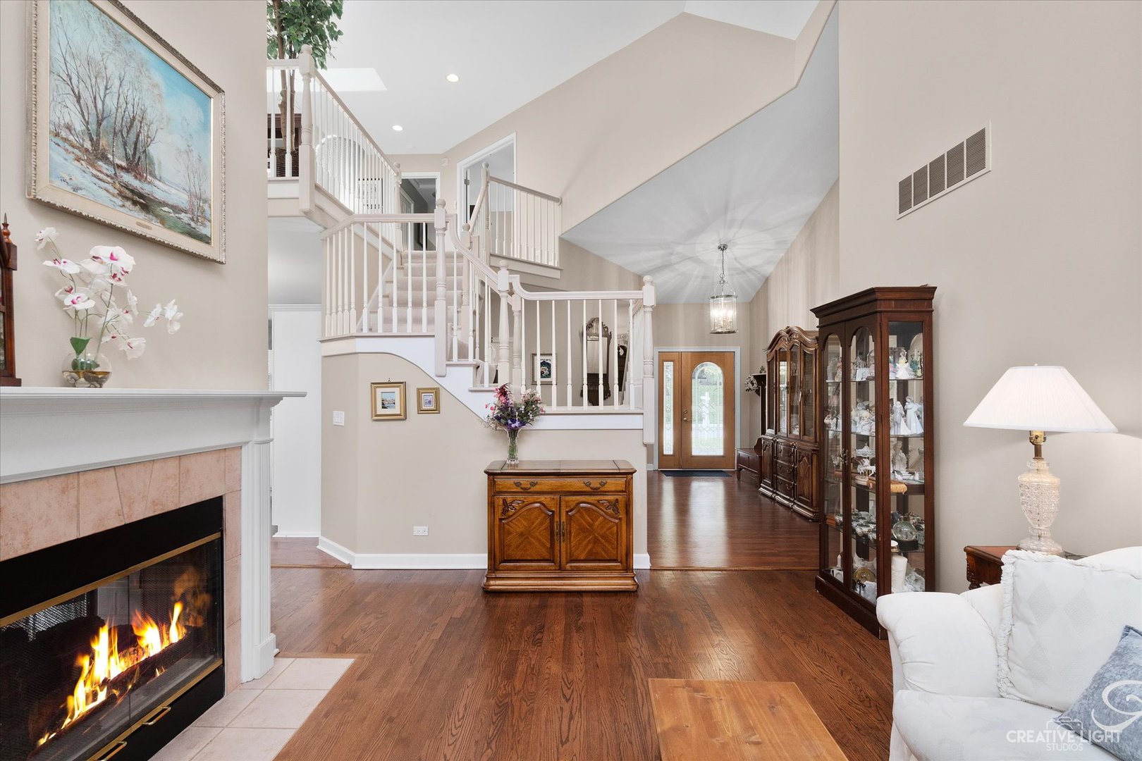 708 Viewpointe Drive St. Charles, IL 60174 - Photo 8 of 38 a living room with furniture a fireplace and a ceiling fan
