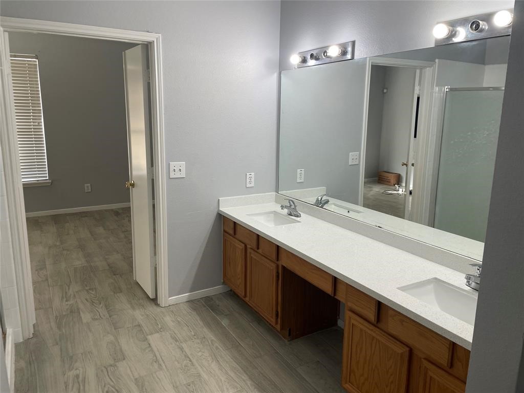 2103 Ragland Drive Houston, TX 77067 - Photo 12 of 18 a bathroom with a sink a mirror and a shower