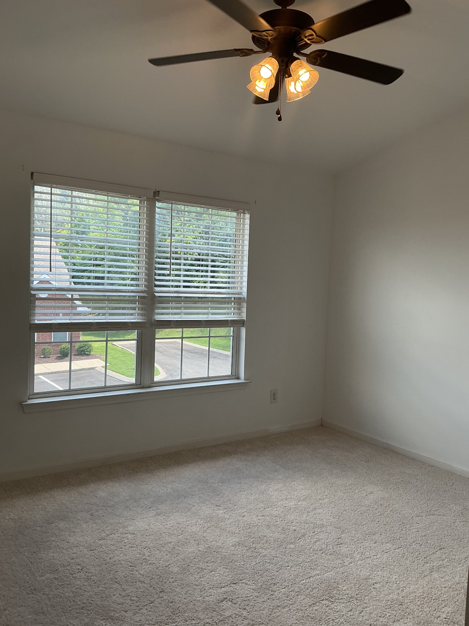 1101 Downs Boulevard, Unit J102 Franklin, TN 37064 - Photo 12 of 21 an empty room with a window and ceiling fan