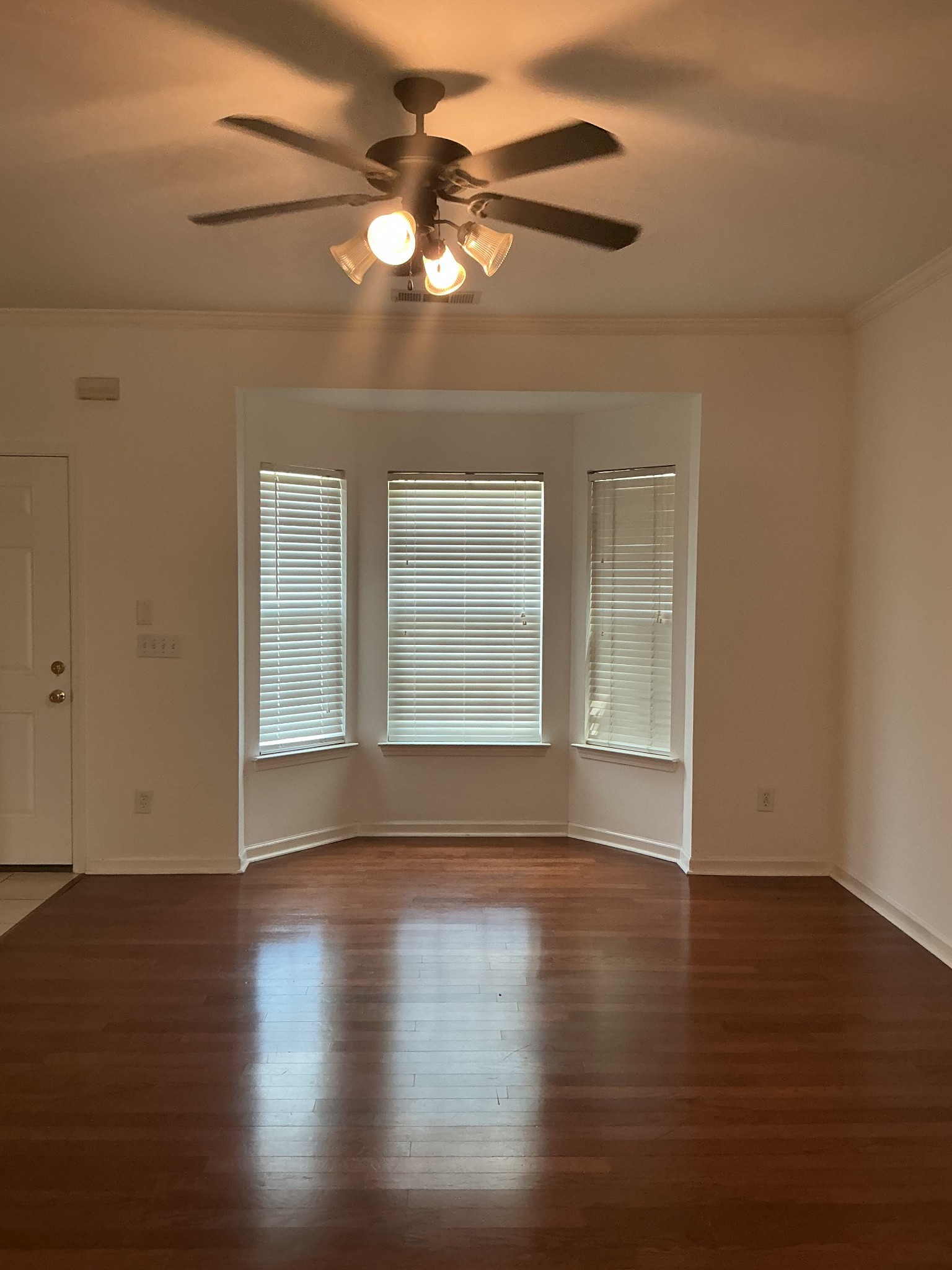 1101 Downs Boulevard, Unit J102 Franklin, TN 37064 - Photo 4 of 21 a view of an empty room with wooden floor and a window
