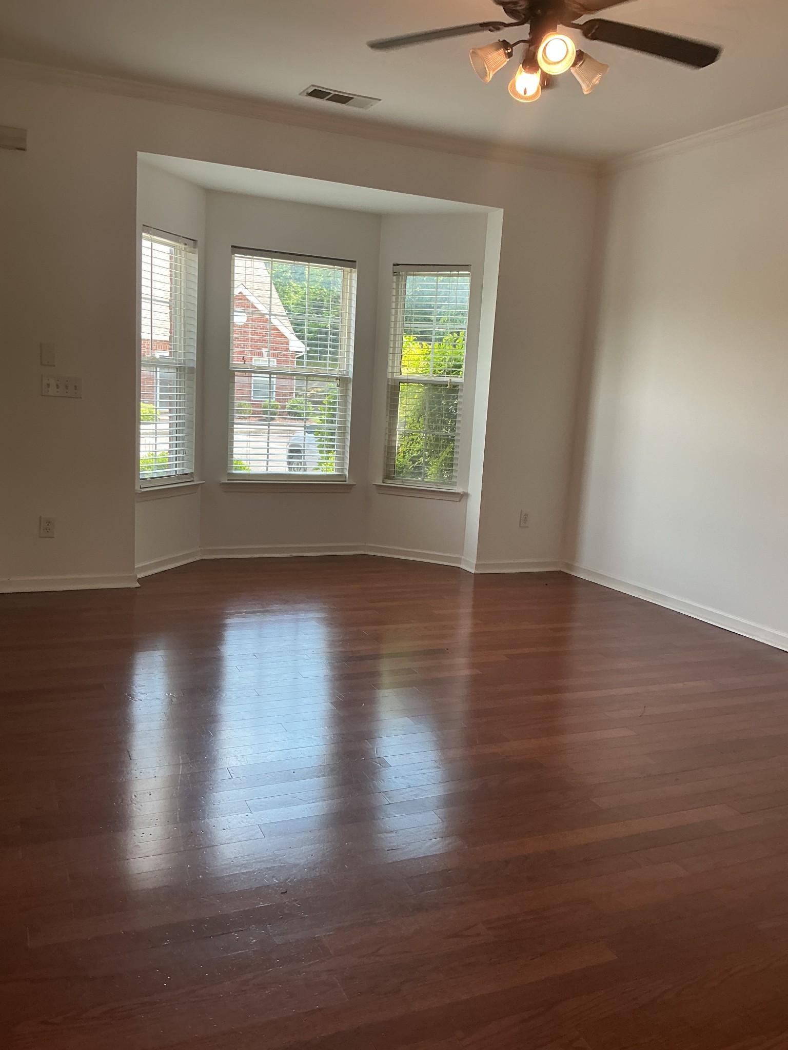 1101 Downs Boulevard, Unit J102 Franklin, TN 37064 - Photo 5 of 21 an empty room with wooden floor and windows