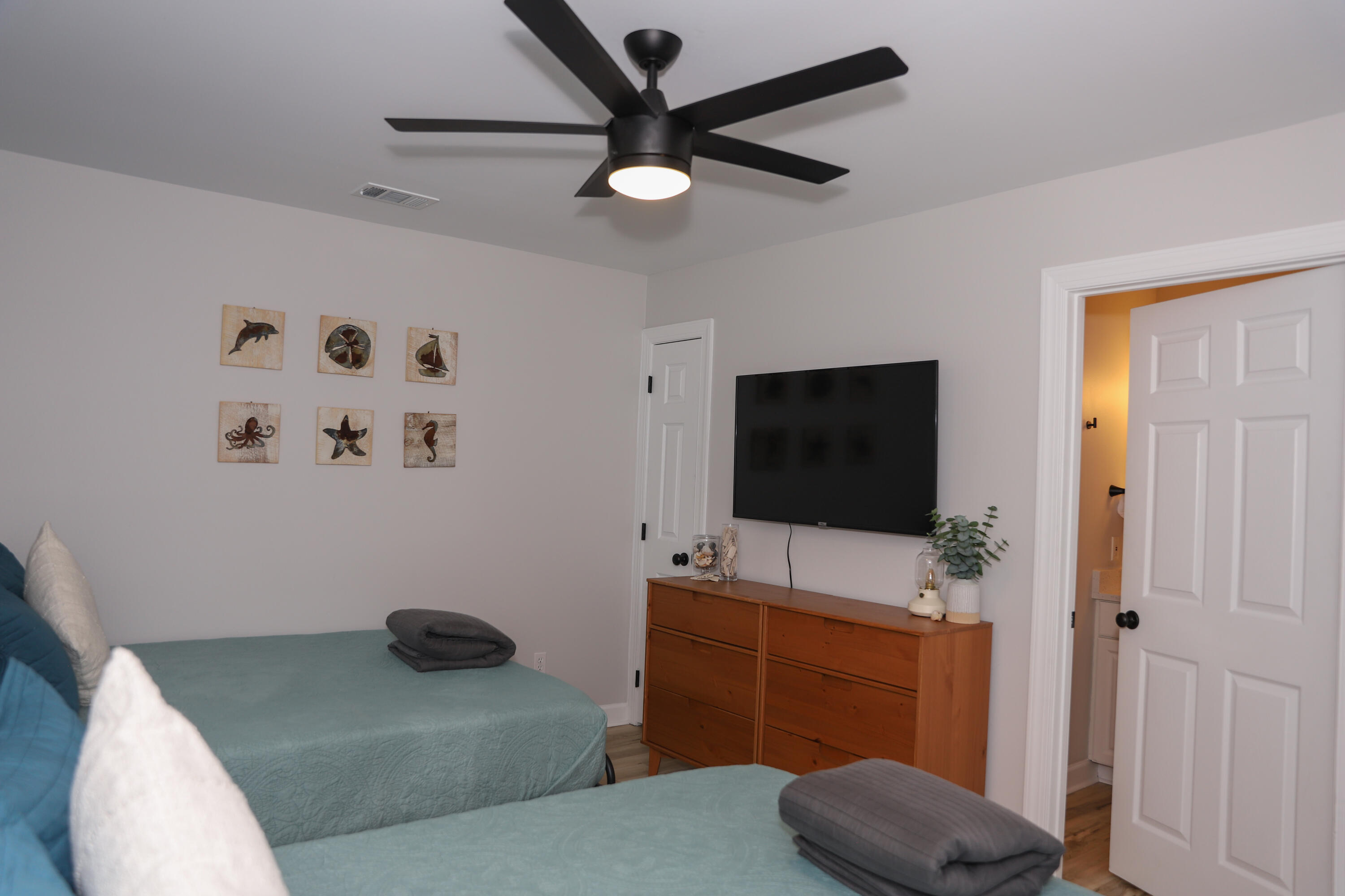 21924 Front Beach Road Panama City Beach, FL 32413 - Photo 103 of 120 a bedroom with a bed and a flat screen tv