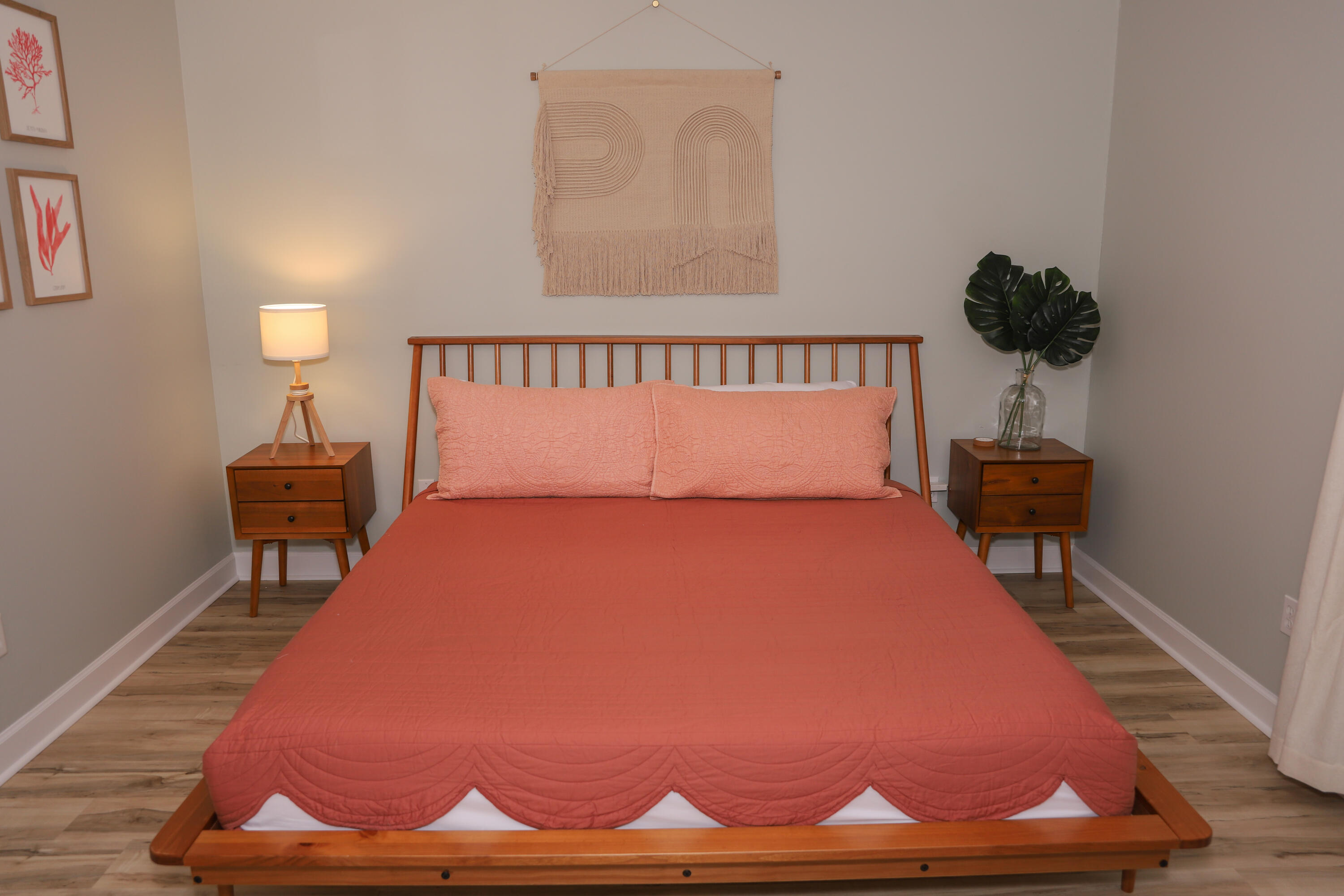 21924 Front Beach Road Panama City Beach, FL 32413 - Photo 112 of 120 a bedroom with a bed and a lamp with wooden floor