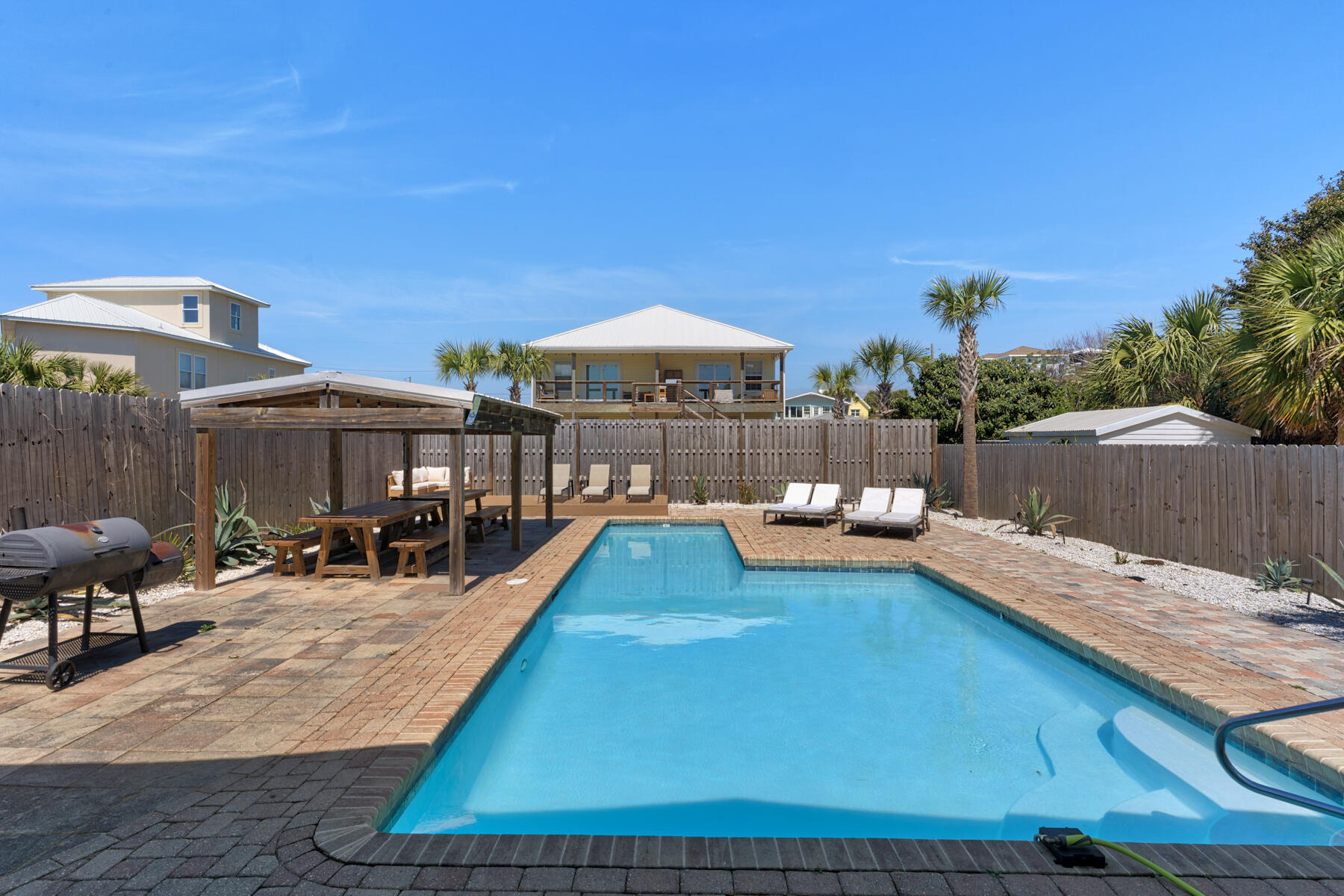 21924 Front Beach Road Panama City Beach, FL 32413 - Photo 23 of 120 a view of a patio with couches and table under an umbrella