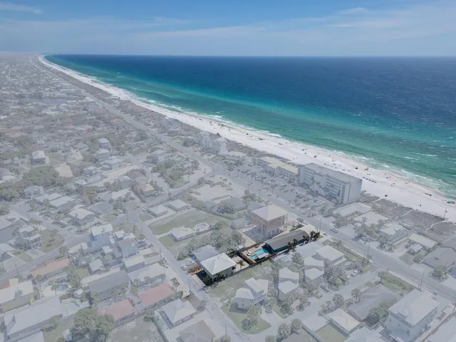 an aerial view of houses with outdoor space and parking