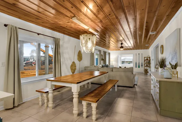 a living room with furniture a rug and a chandelier