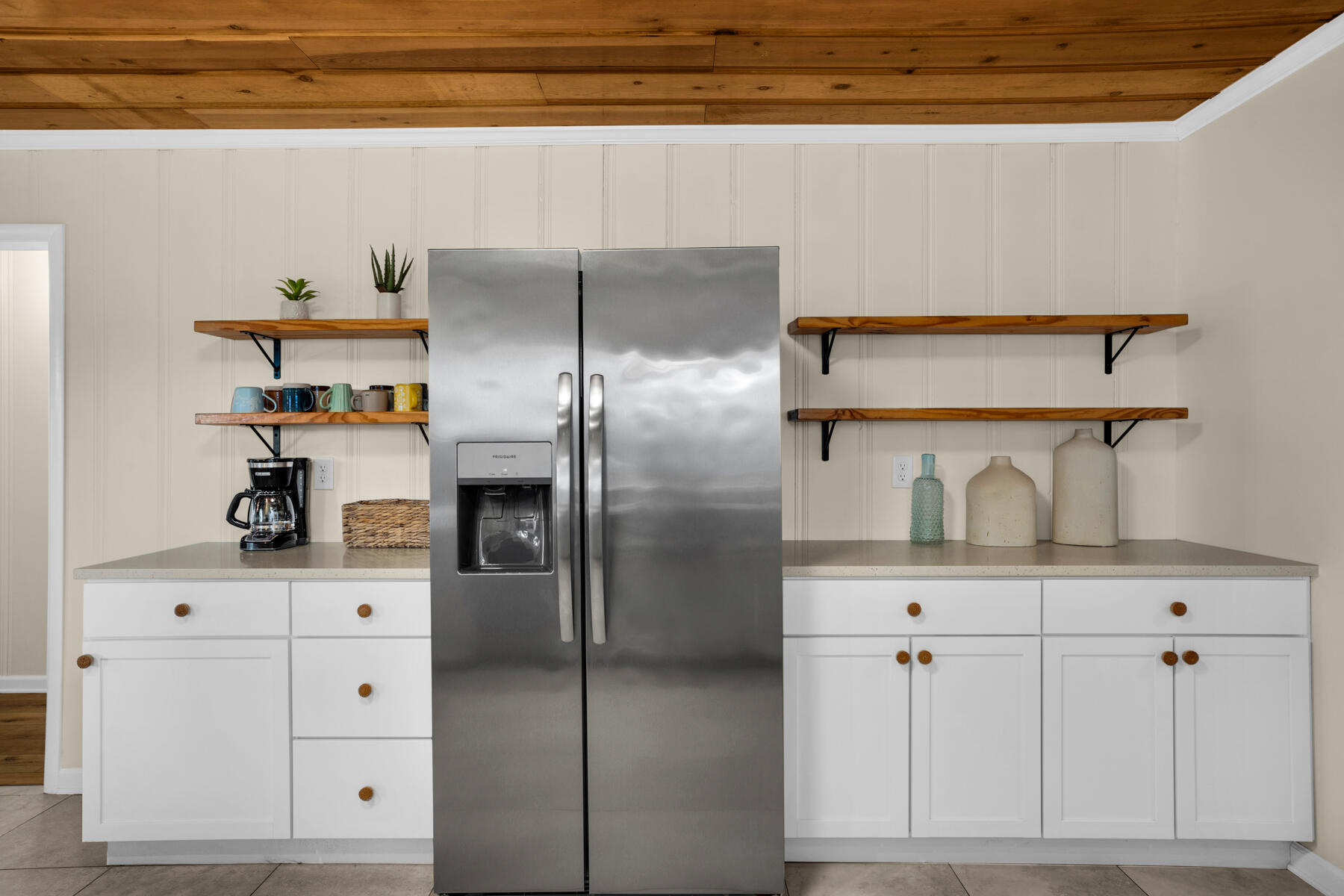 21924 Front Beach Road Panama City Beach, FL 32413 - Photo 46 of 120 a kitchen with white cabinets and refrigerator