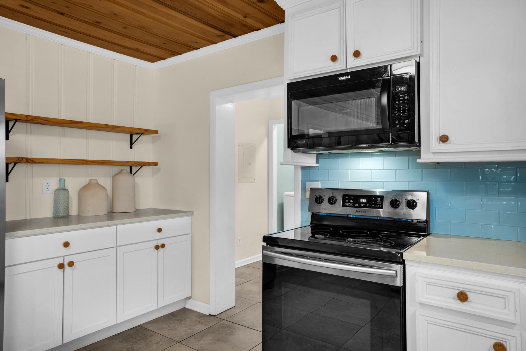 21924 Front Beach Road Panama City Beach, FL 32413 - Photo 48 of 120 a kitchen with stainless steel appliances a stove a microwave and cabinets