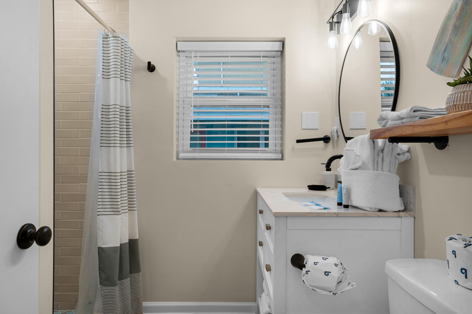 21924 Front Beach Road Panama City Beach, FL 32413 - Photo 60 of 120 a bathroom with a sink and mirror with bathtub