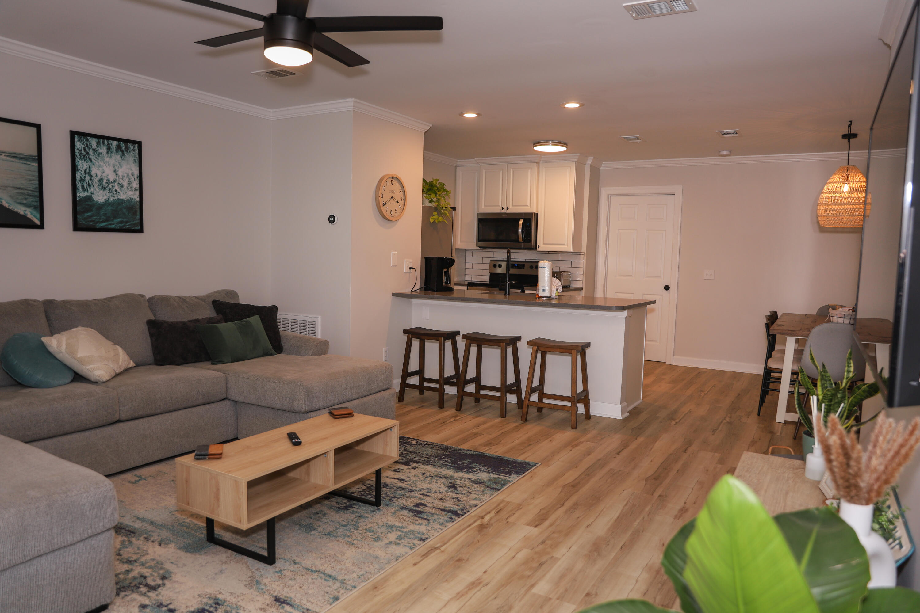 21924 Front Beach Road Panama City Beach, FL 32413 - Photo 89 of 120 a living room with furniture and a flat screen tv with kitchen view