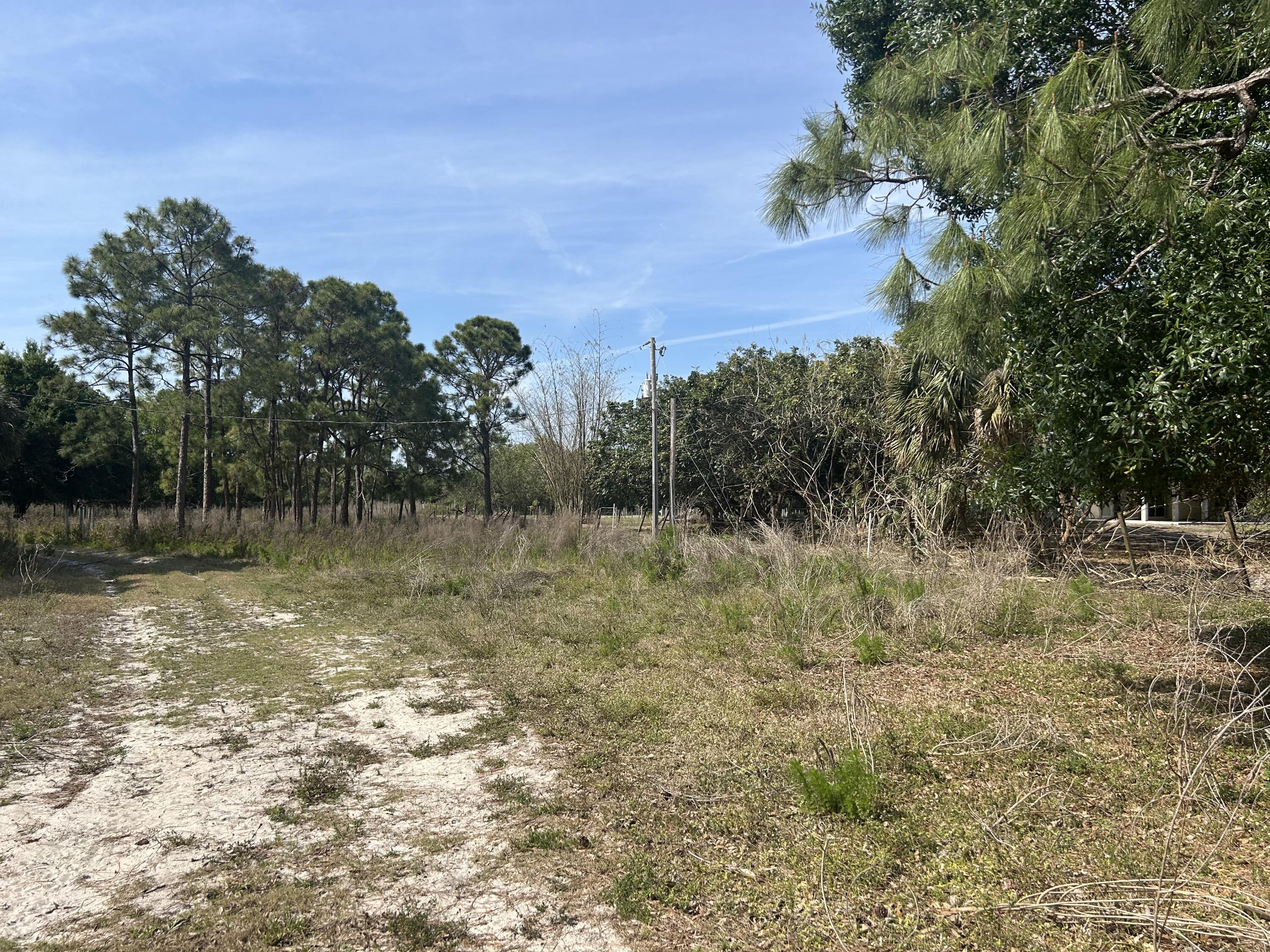 4810 Windmill Road Loxahatchee, FL 33470 - Photo 16 of 34 a view of a lake with houses in the back