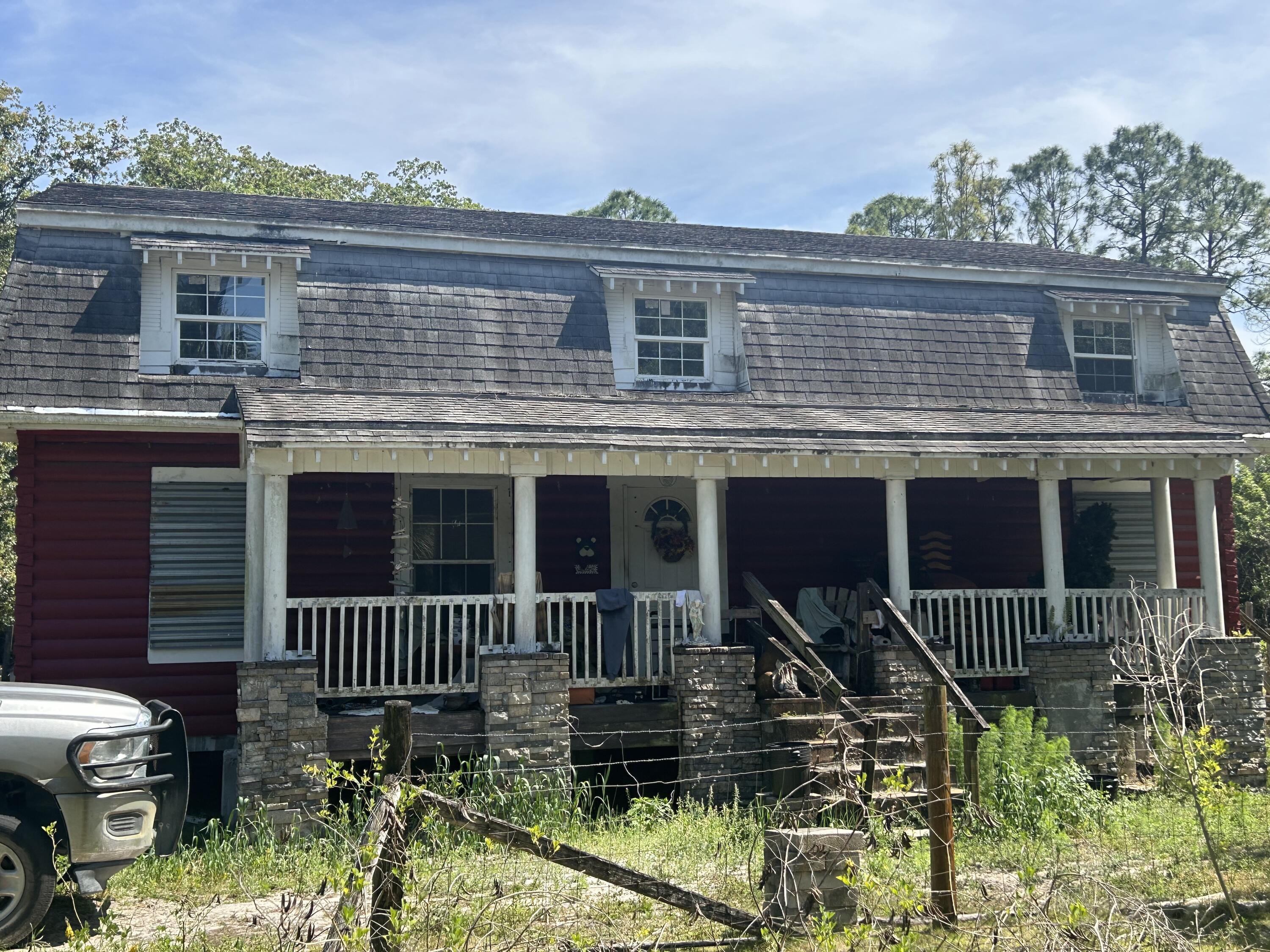 4810 Windmill Road Loxahatchee, FL 33470 - Photo 17 of 34 a view of house with roof deck and chair