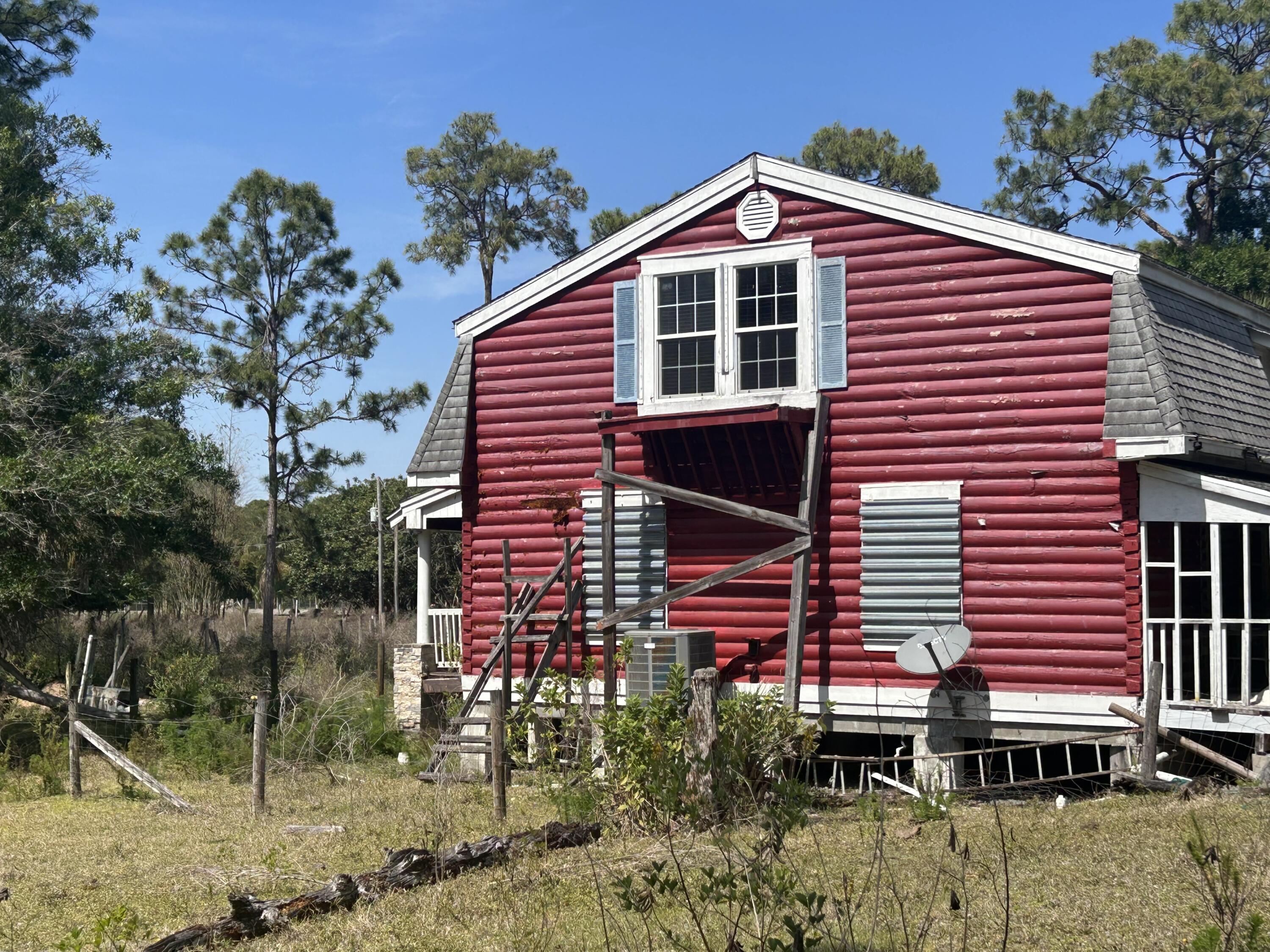 4810 Windmill Road Loxahatchee, FL 33470 - Photo 18 of 34 a front view of a house with a yard