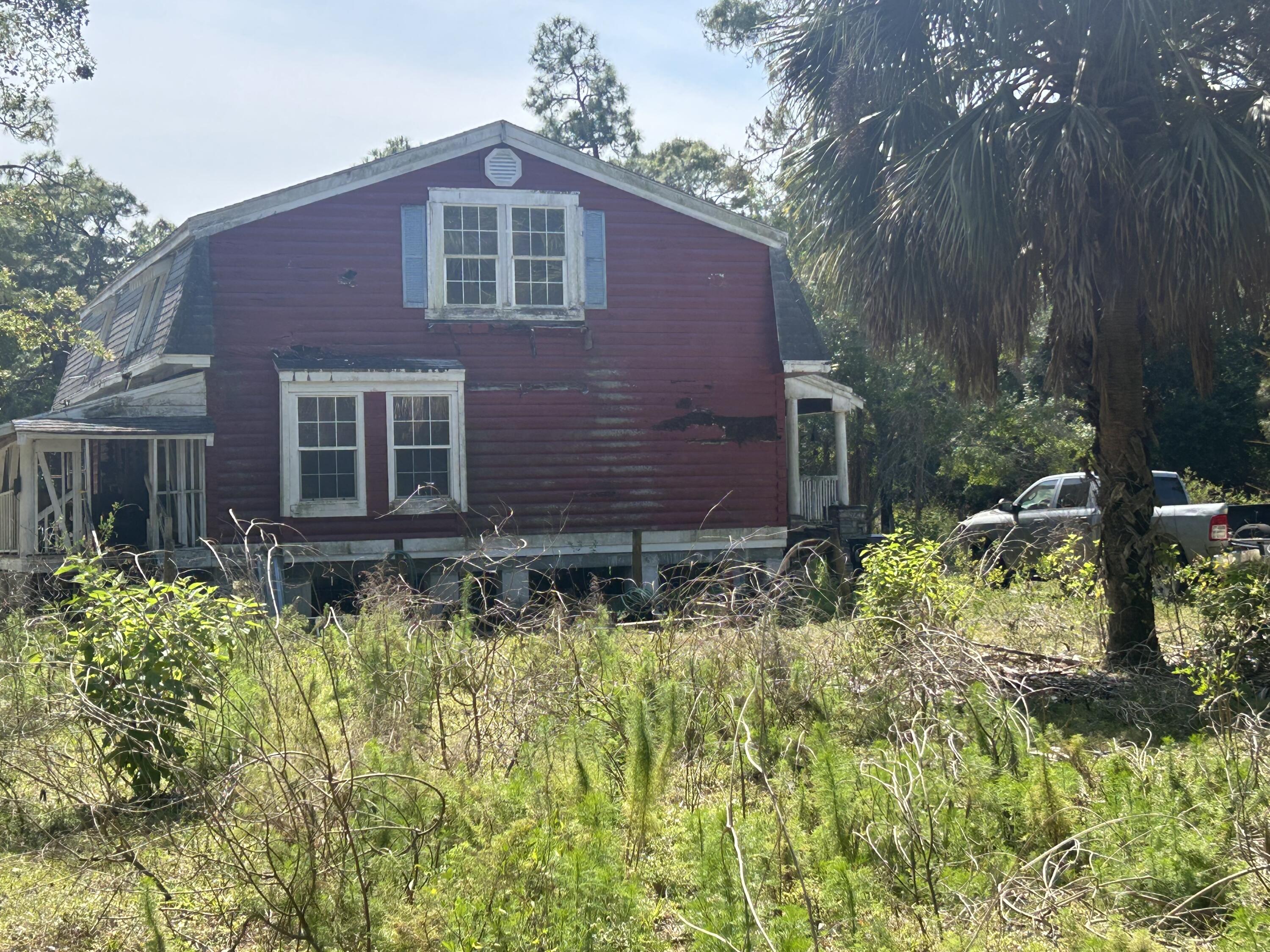 4810 Windmill Road Loxahatchee, FL 33470 - Photo 20 of 34 a front view of a house with a yard