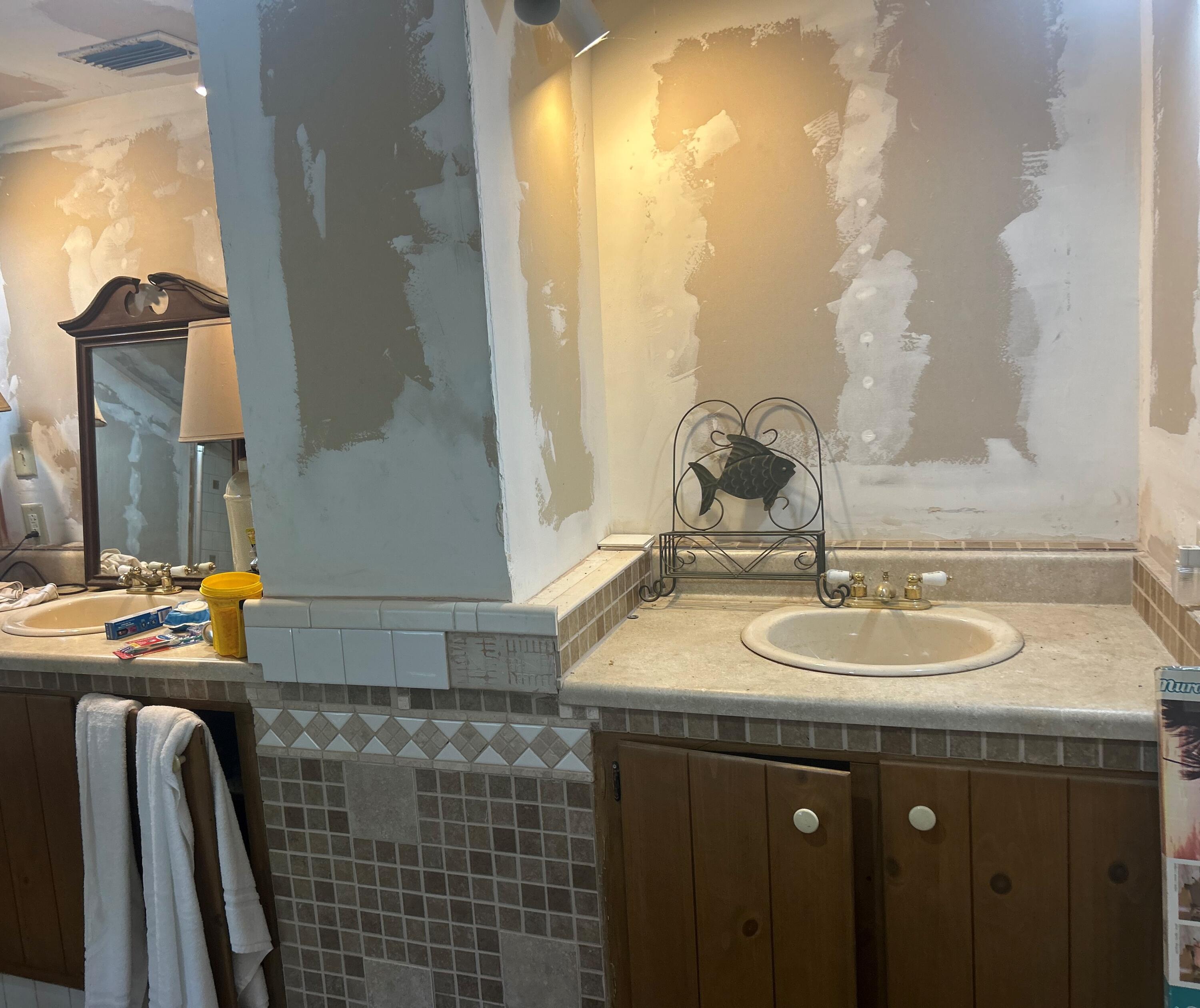 4810 Windmill Road Loxahatchee, FL 33470 - Photo 27 of 34 a bathroom with a granite countertop sink and a mirror