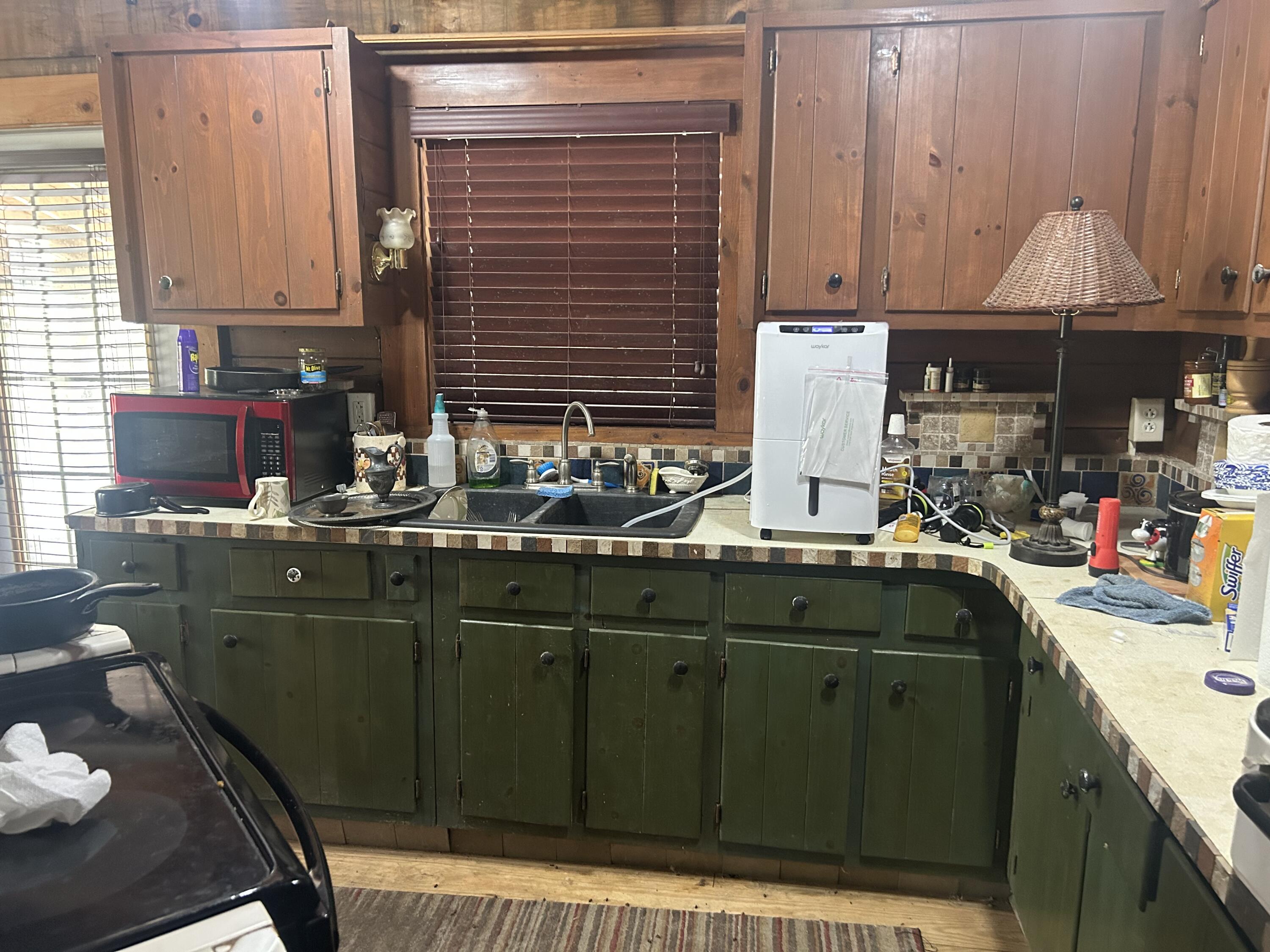 4810 Windmill Road Loxahatchee, FL 33470 - Photo 29 of 34 a kitchen with a sink cabinets and appliances