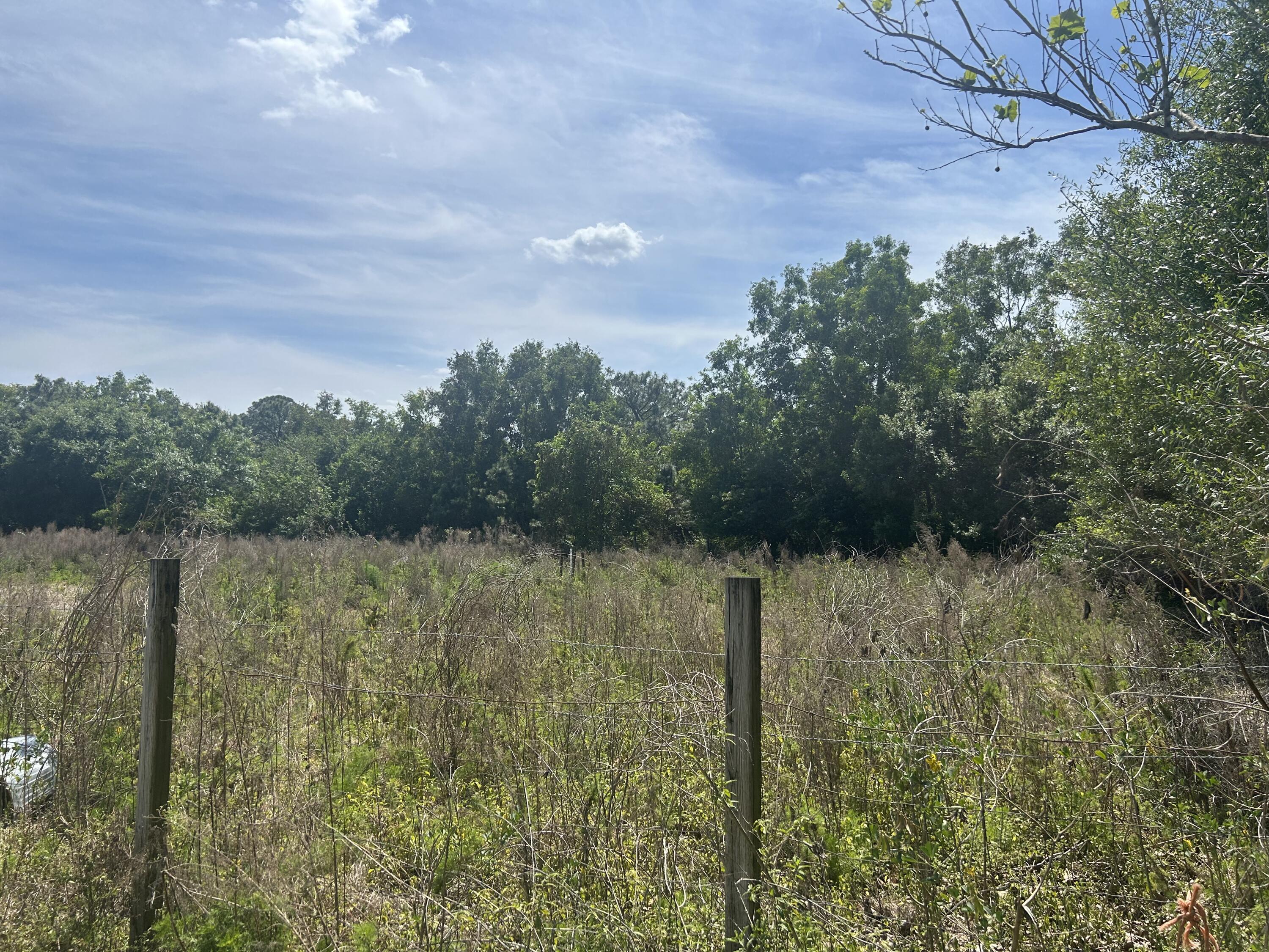 4810 Windmill Road Loxahatchee, FL 33470 - Photo 5 of 34 a view of a lake with a yard and mountain view