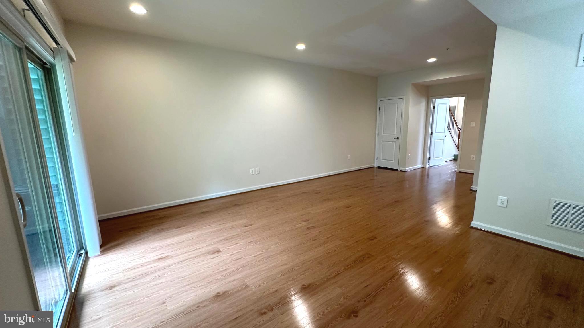 7343 Old Calvary Road Hanover, MD 21076 - Photo 11 of 35 an empty room with wooden floor and windows