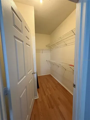 a view of storage and utility room with wooden floor